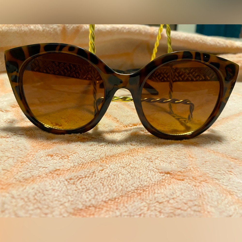 Leopard Cat sunglasses with goldish arms.
